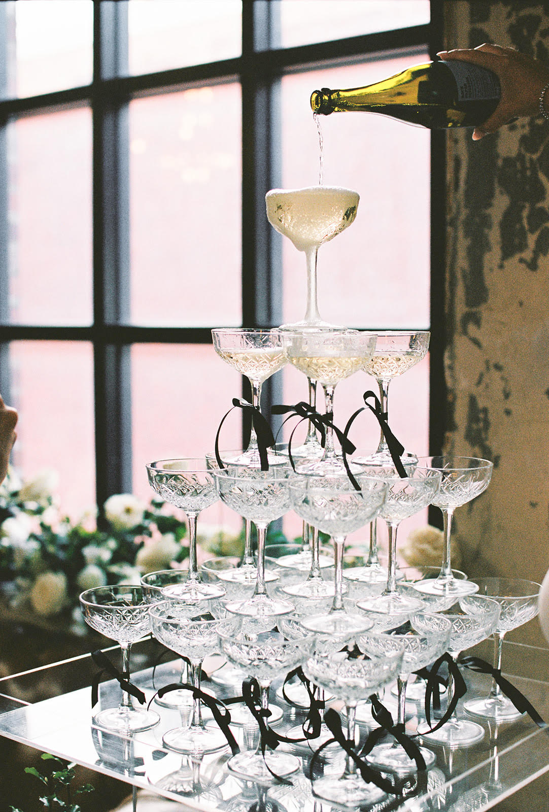 Brisbane wedding planner Bethany Cook pouring champagne fountain at reception